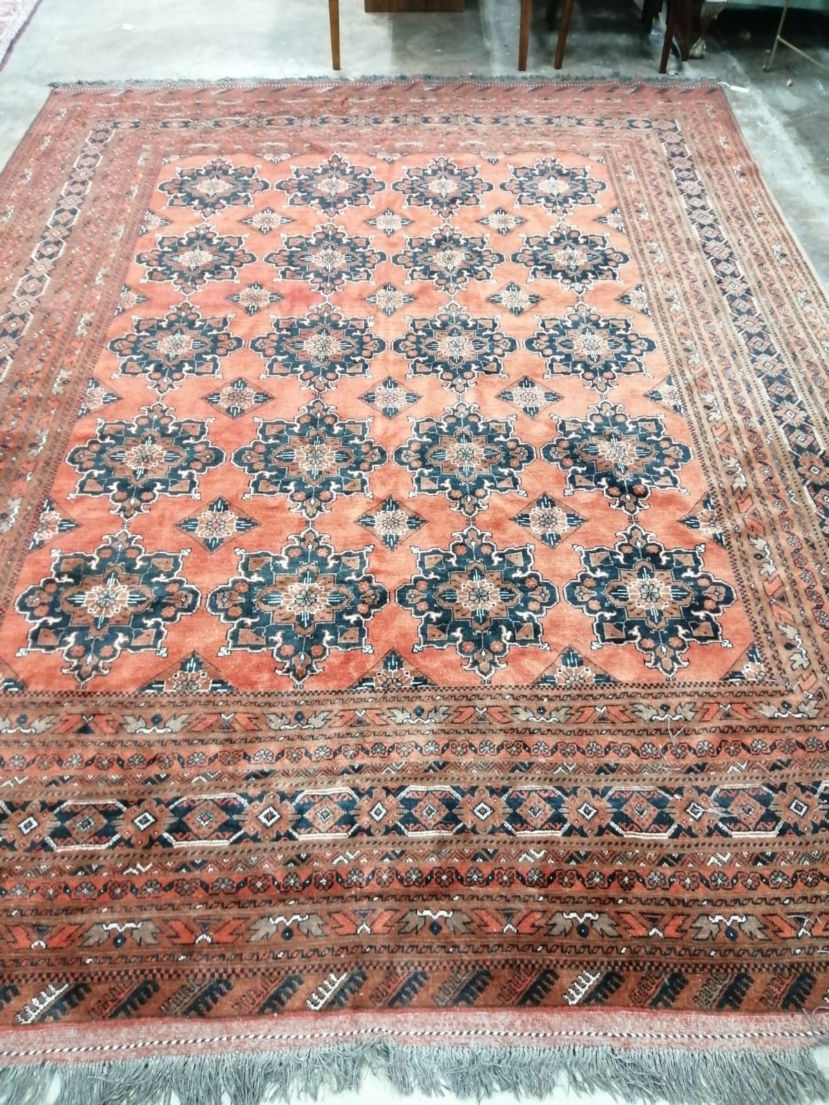 An Afghan red ground carpet, 344 x 264cm